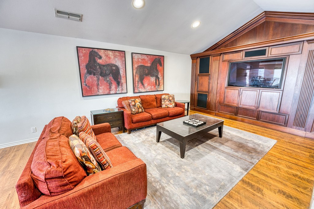 a living room with two couches and a table at Juniper Springs Apartments, Austin, TX